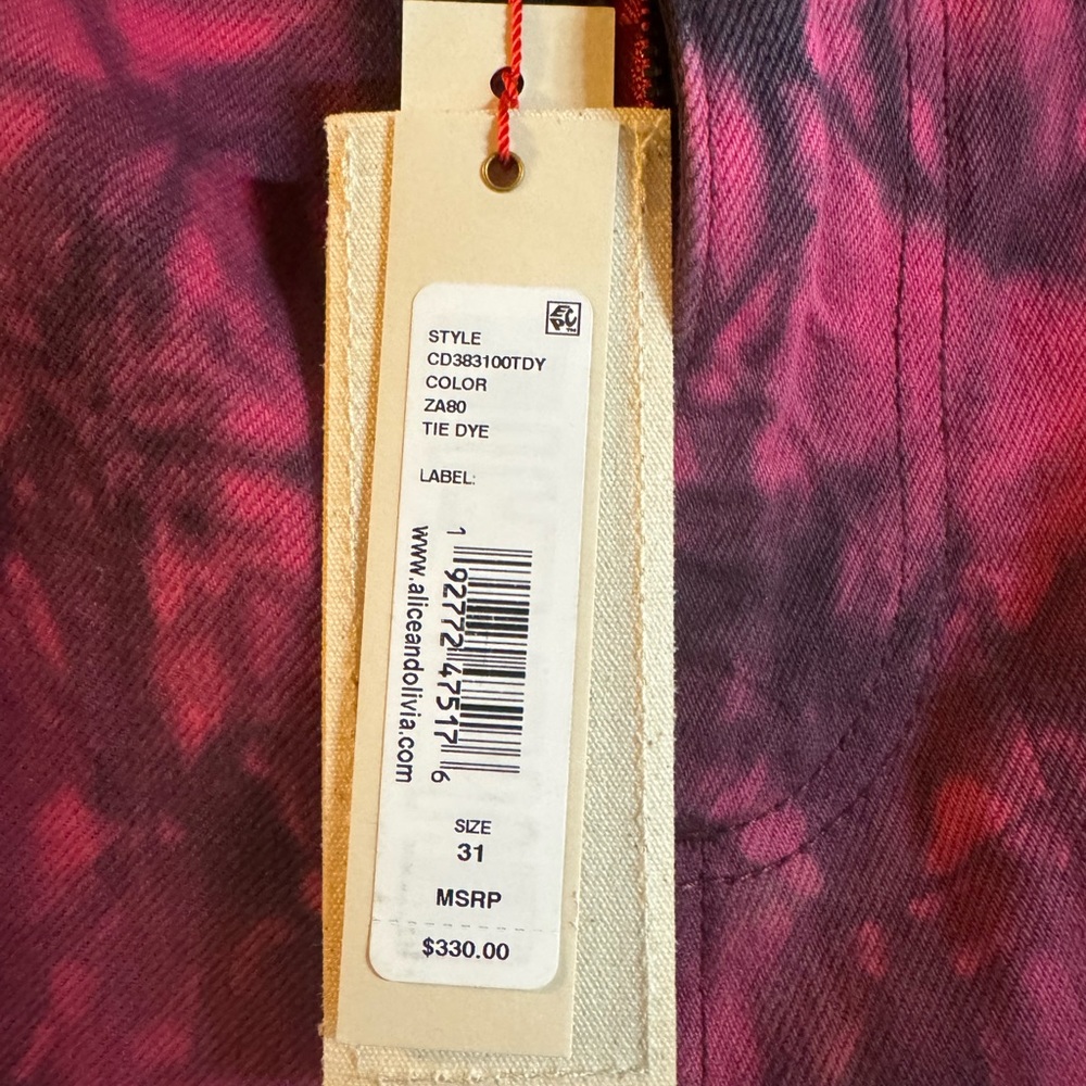 Alice + Olivia Tie Dye pink and black tattered jeans.